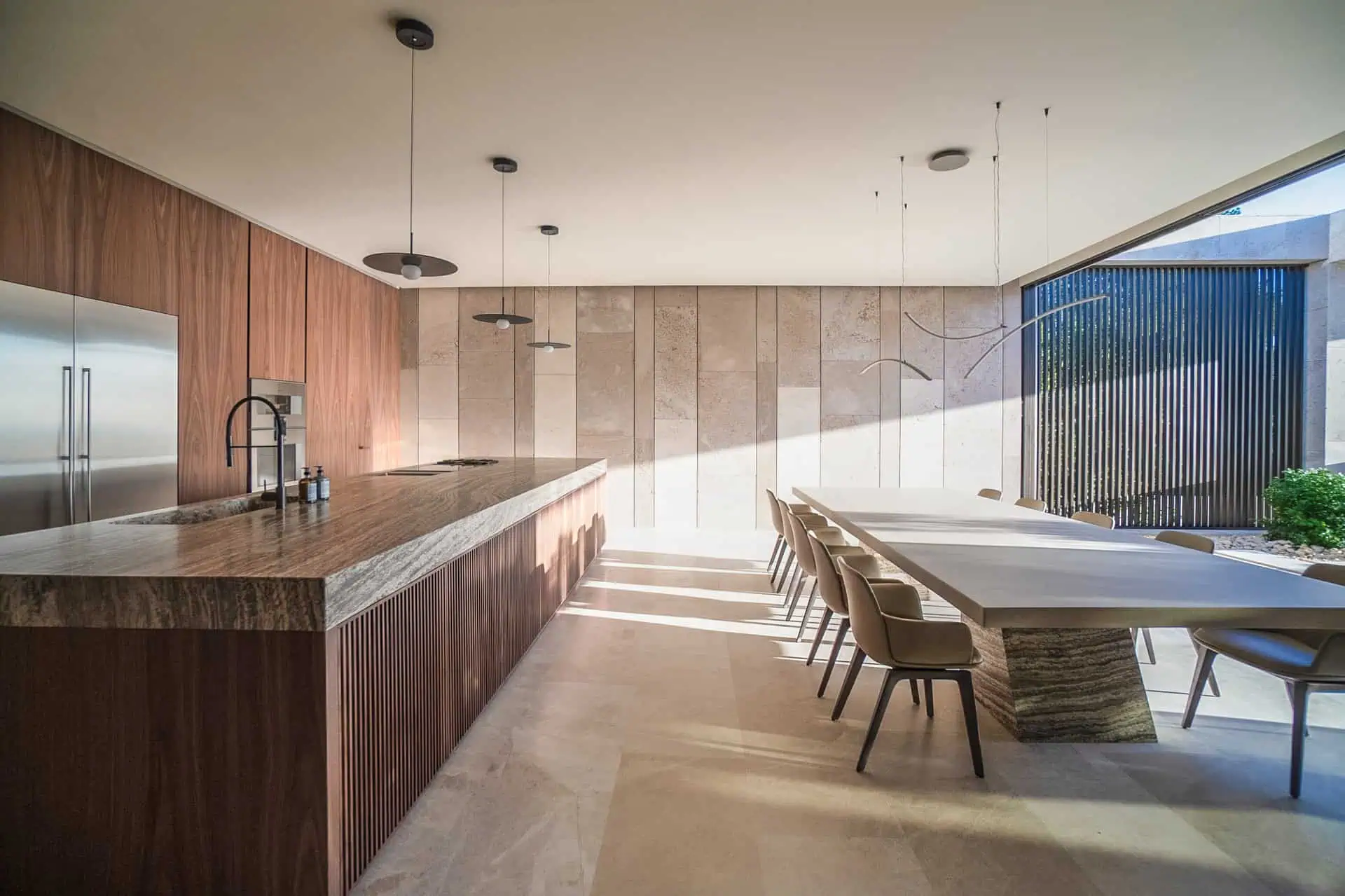 villa tai open kitchen and dining area by ARK Architects, designed as a sensory meeting space where family and friends gather.