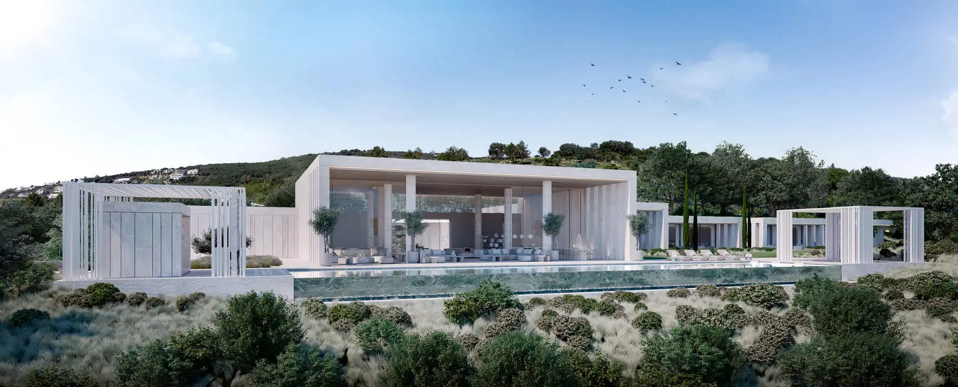 Close-up of the modern facade and infinity pool of Villa NIWA at The Seven Sotogrande, designed by ARK Architects, surrounded by lush natural landscaping