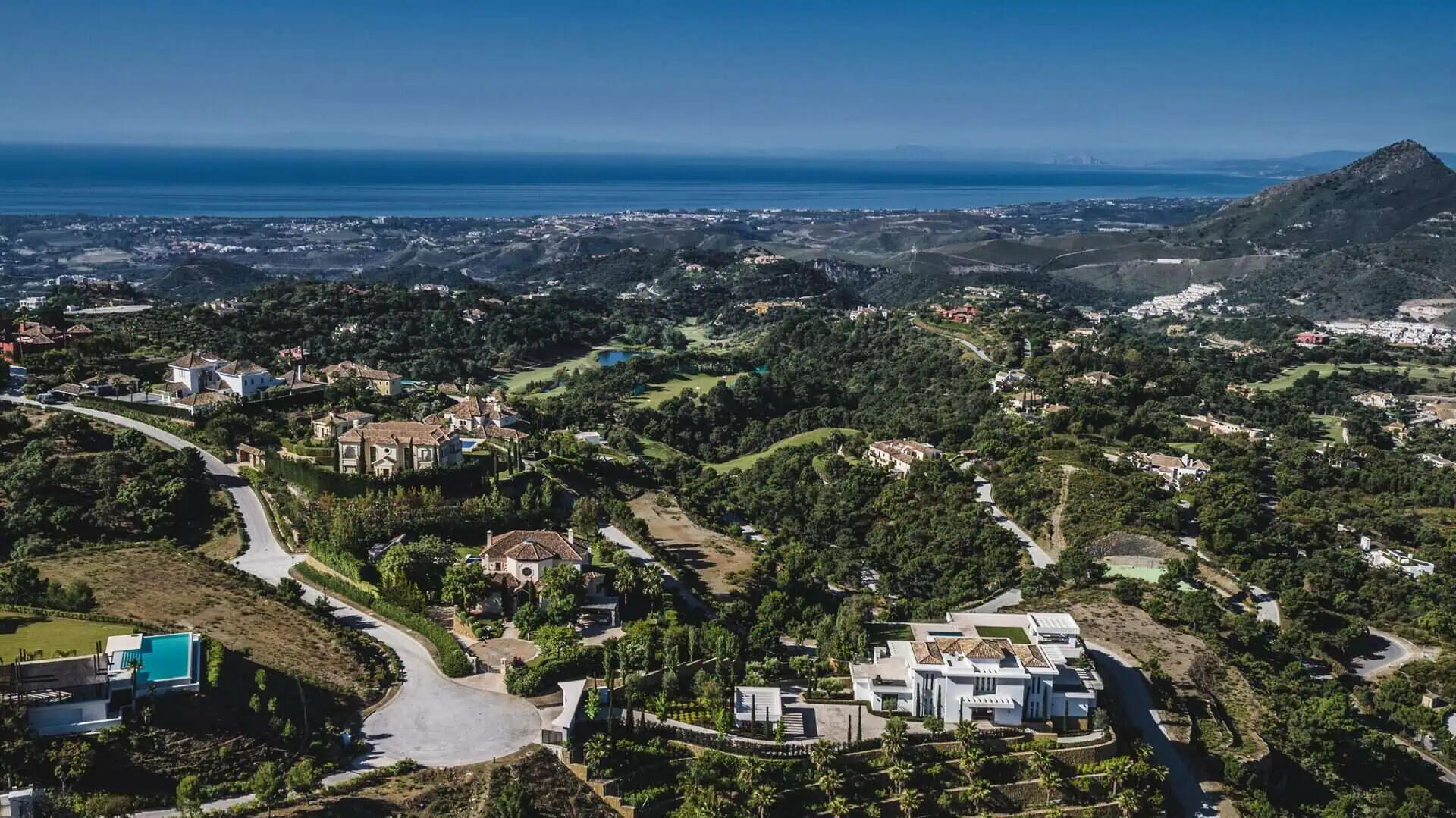 Panoramic landscape of La Zagaleta showcasing luxury villas winding roads and sea horizon ark real estate experts