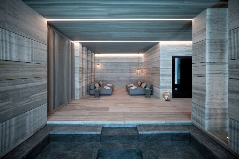 Villa Geneve luxury interior design loungers travertine walls and ambient lighting in spa La Zagaleta by ARK Architects