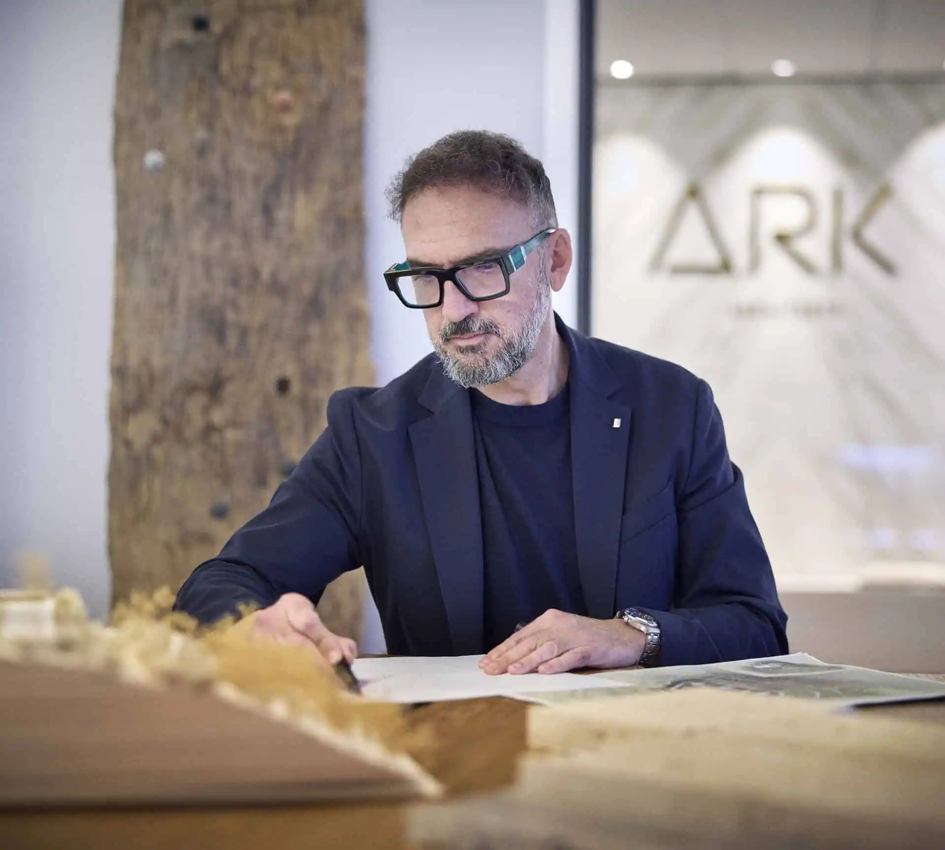 manuel ruiz moriche cofounder and leading architect reviewing plans at desk inside ark architecture studio