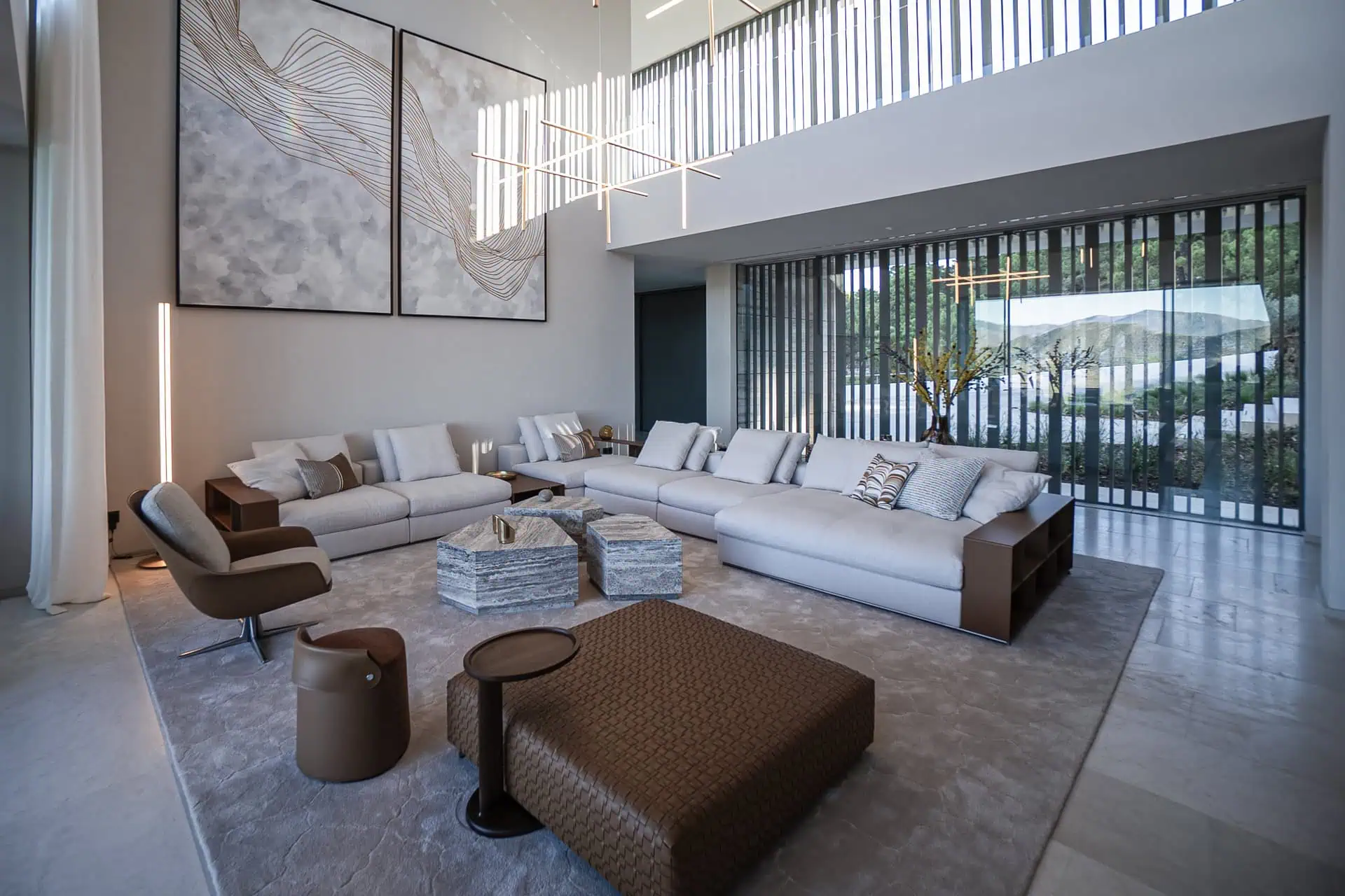 Elegant salon at Villa Geneve in la zagaleta designed by ARK Architects with modular sofas and artistic lighting